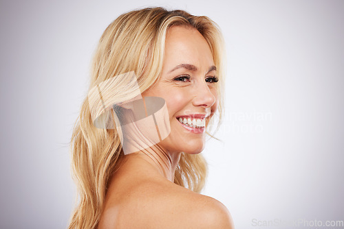 Image of Skincare, happy and mature woman in studio for beauty, wellness and grooming on grey background space. Cosmetic, body care and female model relax in luxury, hygiene and dermatology while isolated