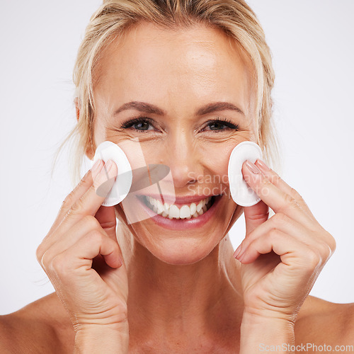 Image of Mature woman, portrait and cotton in studio for skincare, facial and cleaning on grey background. Face, skin and pad by older female model relax in luxury, dermatology or cosmetic grooming isolated