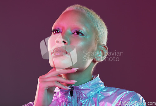 Image of Vaporwave style, black woman and cyberpunk aesthetic with model thinking in a studio. Isolated, glow makeup and futuristic cyber fashion of a young person with chrome clothing and scifi design