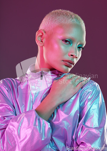 Image of Cyberpunk, model and portrait of high fashion woman with unique style, makeup and hairstyle isolated in a studio neon background. Creative, artistic and colorful female is trendy and stylish