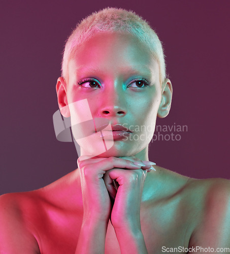 Image of Neon beauty, art and woman with makeup and lights for creative skincare advertising on studio background. Cyberpunk, product placement and model isolated for skin care and futuristic mock up space.