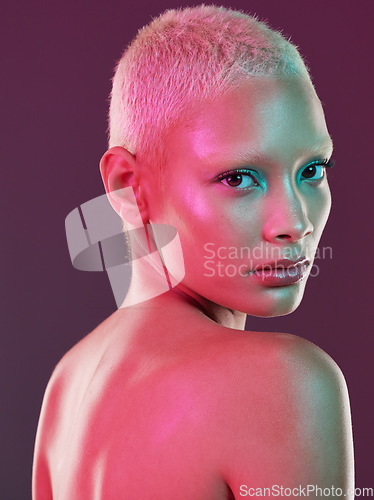 Image of Skincare, cosmetics and portrait of woman with neon makeup and lights for creative advertising on studio background. Cyberpunk, product placement and model isolated for and futuristic beauty mockup.