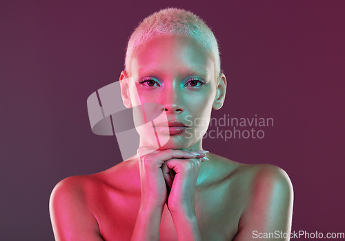 Image of Skincare, beauty and portrait of woman with neon makeup and lights in creative advertising on studio background. Cyberpunk, product placement and model isolated for futuristic skin care mockup space.