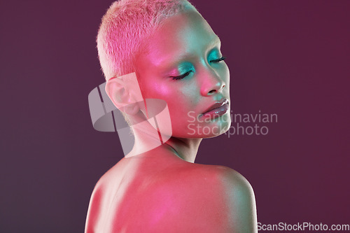 Image of Skincare, cosmetics and woman with neon makeup and lights for creative advertising on studio background. Cyberpunk, product placement and model isolated for and futuristic beauty and art mockup space