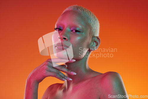 Image of Cyberpunk, neon beauty and portrait of woman with makeup and light in creative advertising on orange background. Art, product placement and model isolated for skincare and futuristic mockup in studio