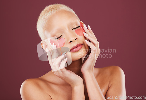 Image of Eye patches, face beauty and skincare of black woman with cosmetics and dermatology treatment. Relax, spa and young model in a studio with wellness facial for eyes and cosmetic mask with collagen