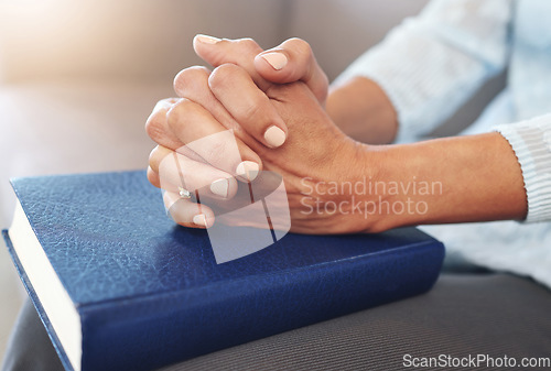 Image of Bible, worship and hands of old woman in living room for religion, book and Christian faith. Spiritual, God and prayer with senior lady praying with holy text at home for wellness, believe and goal