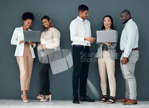 Image of Business people, group and laptop with coach for learning, proposal and teamwork by wall background together. Young executive team, diversity and mentor with men, women and computer for web design