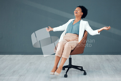 Image of Chair, carefree and mockup with a business black woman sliding on the floor of her office feeling stress free. Freedom, relax and success with a crazy female employee riding a seat in the workplace