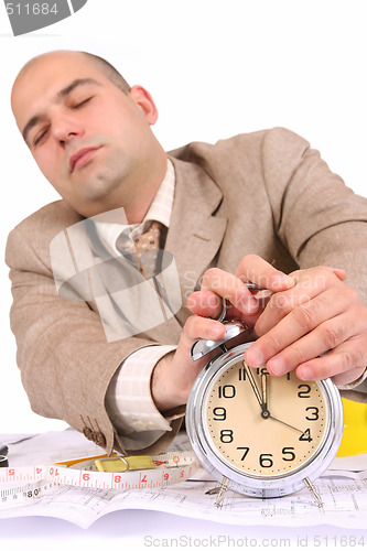 Image of A businessman sleepy with architectural plans