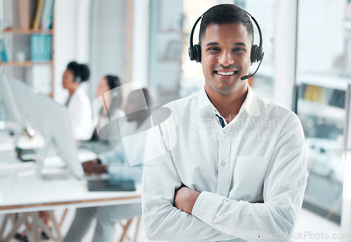 Image of Crm, manager or portrait of man in call center smiles with pride, helping advice or networking online. Face, smile or happy Indian insurance agent in communication at customer services or sales job