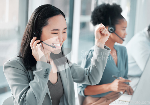Image of Call center, success and asian woman at computer in office for customer service, telemarketing and deal. Happy, target and contact us with consultant for technical support, advisory and winner