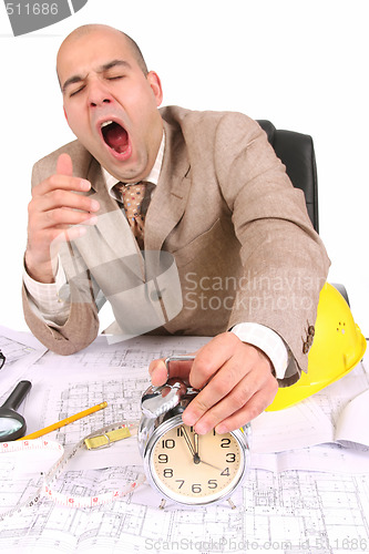 Image of A businessman sleepy with architectural plans
