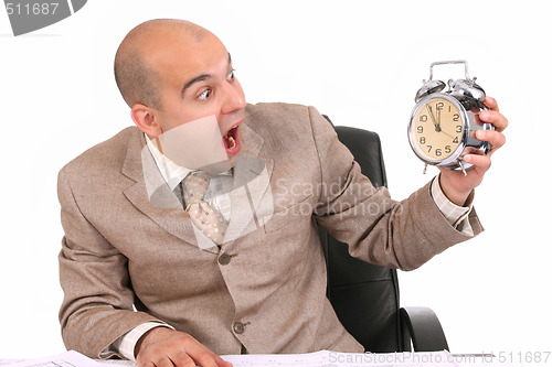 Image of businessman looking at clock alarm