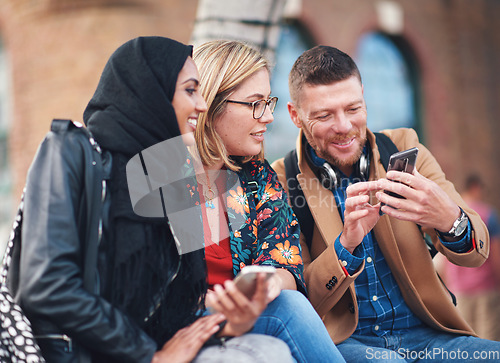 Image of Friends, diversity and happy people with phone communication and funny meme. Hijab, muslim and talking women and adult learning group and international student community on college steps