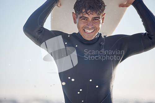 Image of Portrait, vacation and man holding surfboard at the beach, sea or ocean with a smile and is happy on a summer day. Man, surfing and male surfer with swimsuit in Australia with freedom on the waves