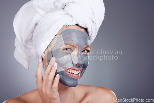 Image of Woman, clay makeup and mask portrait for facial, detox beauty and studio background. Happy female model, charcoal skincare product and face cosmetics for cleaning, shower and aesthetic transformation