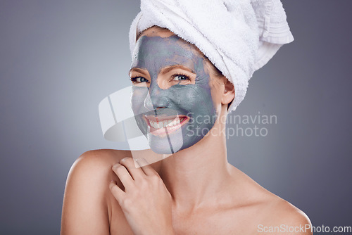 Image of Clay, makeup and woman with mask for portrait facial, healthy beauty spa and studio background. Happy female model, charcoal skincare product and face cosmetics for acne, shower or aesthetic wellness