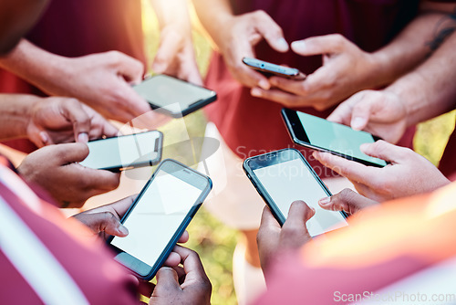 Image of Hands, phone and networking on mockup screen in sports collaboration, social media or communication. Hand of group football players on smartphone for 5G connection, share or mobile app sync in circle