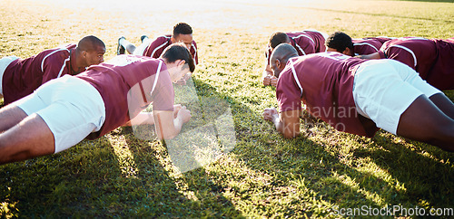 Image of Man, team and plank on grass field for sports training, fitness and collaboration in the outdoors. Group of sport rugby players in warm up exercise together for teamwork preparation, match or game