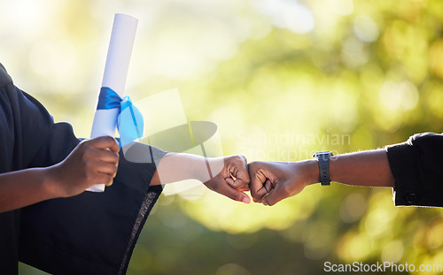 Image of Graduation, education and hands of friends fist bump in celebration of certificate, study and success on bokeh. University, people and hand in support of goal, motivation and unity in accomplishment