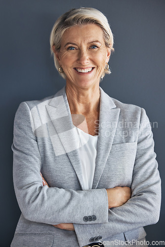 Image of Smile, confidence and portrait of mature businesswoman with arms crossed isolated on blue background. Success, vision and leadership, happy senior woman in corporate management standing in studio.