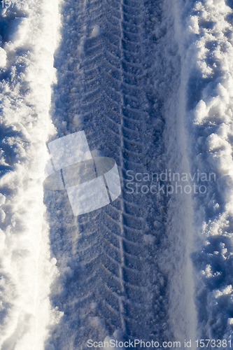 Image of car tire in the snow