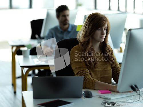 Image of Serious, computer and typing with business woman in office for web design, focus and research. Vision, technology and internet with employee in digital agency for idea, startup and email