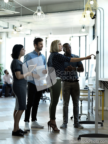 Image of Creative people, meeting and collaboration on whiteboard for planning, brainstorming strategy or schedule at office. Group of employee workers in teamwork, ideas or project management for startup