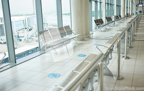 Image of Airport, lounge chairs and terminal waiting room for global travel, covid regulations or immigration journey. Empty airplane lobby, seat or space of commercial flight, building interior or background