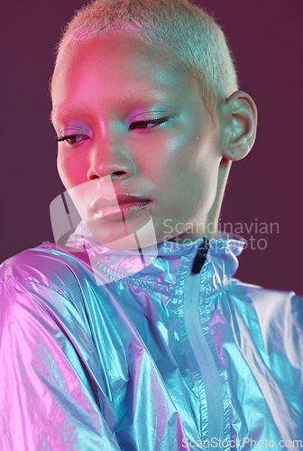 Image of Beauty, cyberpunk and high fashion black woman with unique style, makeup and hairstyle isolated in a studio neon background. Creative, artistic and bright and colorful female is trendy and stylish