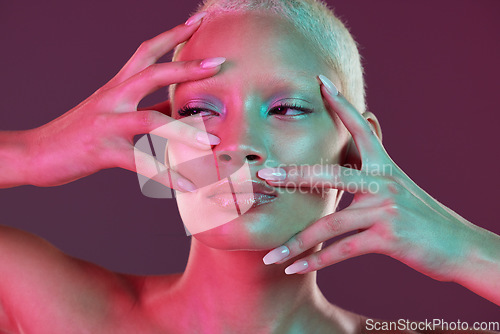 Image of Neon makeup, woman with hands in face, skincare and lights for creative advertising on studio background. Cyberpunk, fantasy girl and art model isolated for skin care and futuristic mock up space.