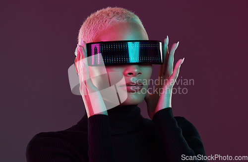 Image of Woman, vr glasses and metaverse for futuristic gaming, digital transformation and tech. Cyberpunk person on studio background with augmented reality headset for 3d and cyber world fantasy experience