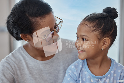 Image of Happy, smile and relax with mother and girl for bonding, quality time and affectionate. Happiness, care and support with mom and daughter at home for black family, smiling and cute together