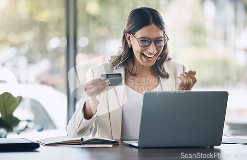 Image of Finance, credit card and winner with woman and laptop in office for savings, investment or online shopping sale. Success, fintech and ecommerce with customer and website for deal, payment or offer