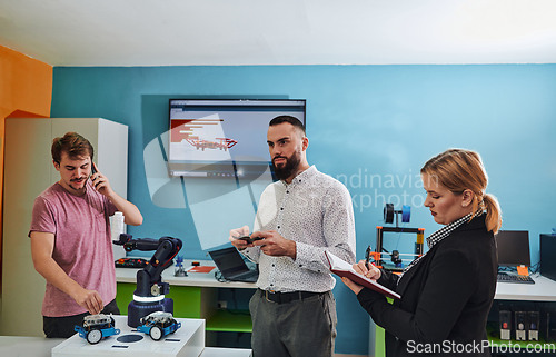 Image of A group of students working together in a laboratory, dedicated to exploring the aerodynamic capabilities of a drone