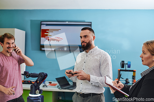 Image of A group of students working together in a laboratory, dedicated to exploring the aerodynamic capabilities of a drone