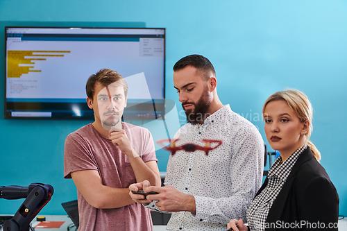 Image of A group of students working together in a laboratory, dedicated to exploring the aerodynamic capabilities of a drone