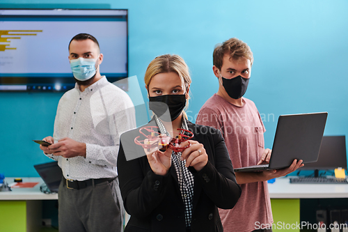 Image of A group of students working together in a laboratory, dedicated to exploring the aerodynamic capabilities of a drone