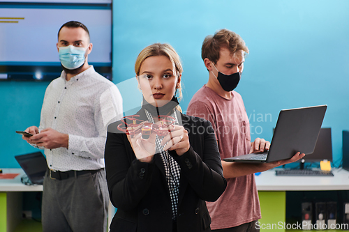 Image of A group of students working together in a laboratory, dedicated to exploring the aerodynamic capabilities of a drone