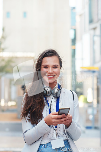 Image of Phone, happy and portrait of a woman in the city walking to her office while networking online. Happiness, smile and female browsing on social media, mobile app or internet while commuting to work.