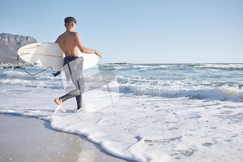Image of Surfing, man and walking in waves, sea and ocean of summer, freedom and blue sky mockup in Cape Town. Surfer guy, board and swimming in water, beach and relax on holiday, travel or sunshine adventure