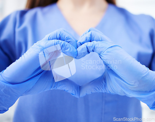 Image of Woman, doctor and hands in heart emoji for healthcare, life insurance or sign on mockup at hospital. Hand of medical female expert GP showing love, hearty symbol or gesture for medicare assurance