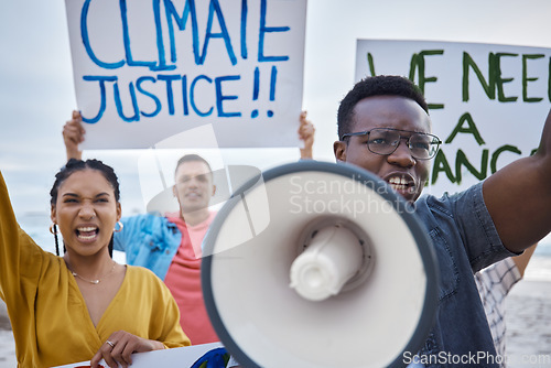 Image of Climate change sign, protest and black man with megaphone for freedom movement. Angry, crowd screaming and young people by the sea with world support for global, social and equality action at beach