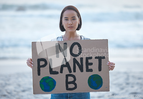 Image of Protest, planet earth and woman with a sign for climate change to stop pollution and global warming at beach. Political, nature activism and portrait of Asian female with board by ocean for march