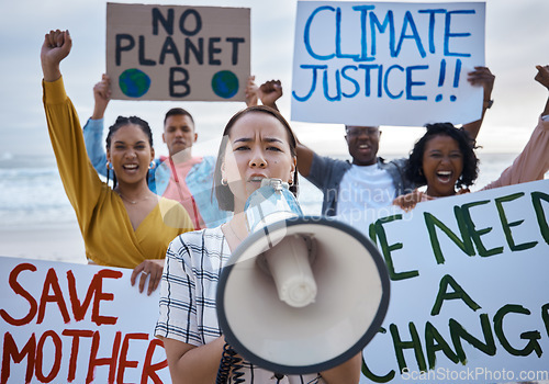 Image of Climate change protest, megaphone and Asian woman with crowd at beach protesting for environment, global warming and to stop pollution. Save the earth, portrait and female leader shouting on bullhorn