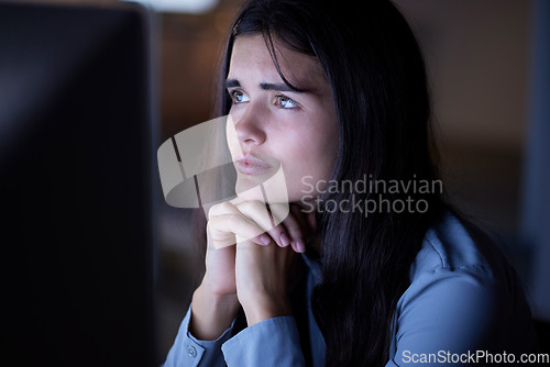 Image of Thinking, working and woman in office at night reading information on computer while doing research. Overtime, professional and female employee contemplating and planning company report in workplace.