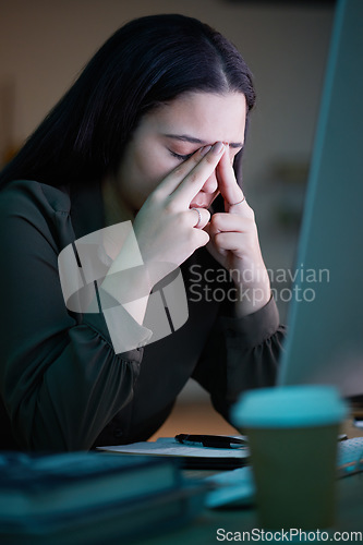 Image of Woman with headache, working on project at night in office with computer and mental health of corporate business worker. Young overworked person at desk, from late workload and employee burnout
