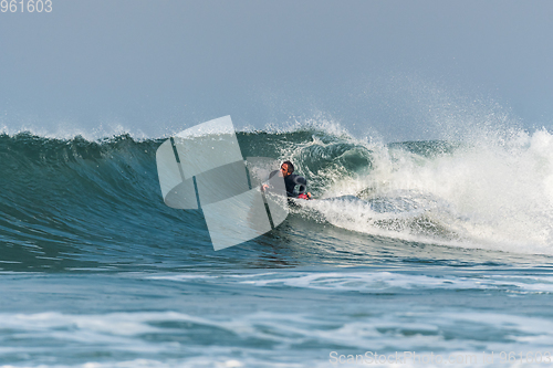 Image of Bodyboarder surfing ocean wave