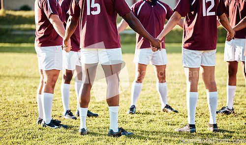 Image of Man, team and holding hands in fitness for sports motivation, collaboration or coordination and goal on field. Group of men huddle in circle for teamwork, community or sport strategy and solidarity